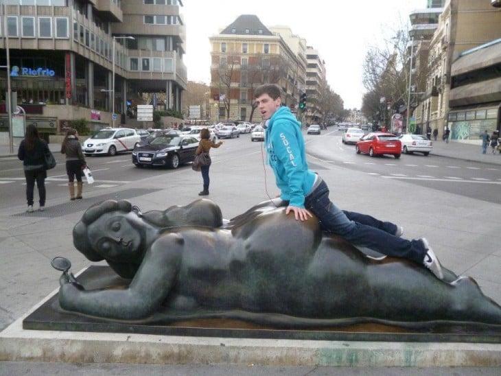 hombre haciendo cosas inmorales a estatua