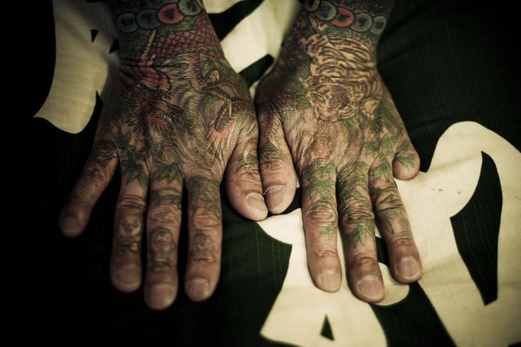 manos tatuadas de un yakuza, dedo cortado