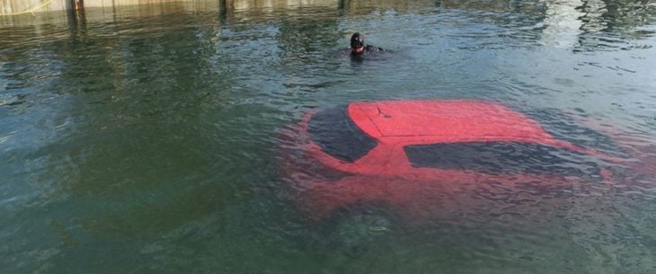 Mujer conduce hacia un lago siguiendo su GPS