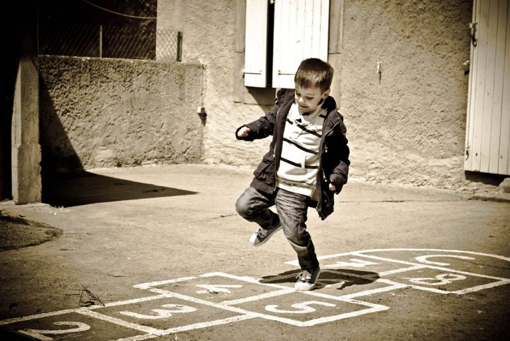 Niño jugando a la rayuela