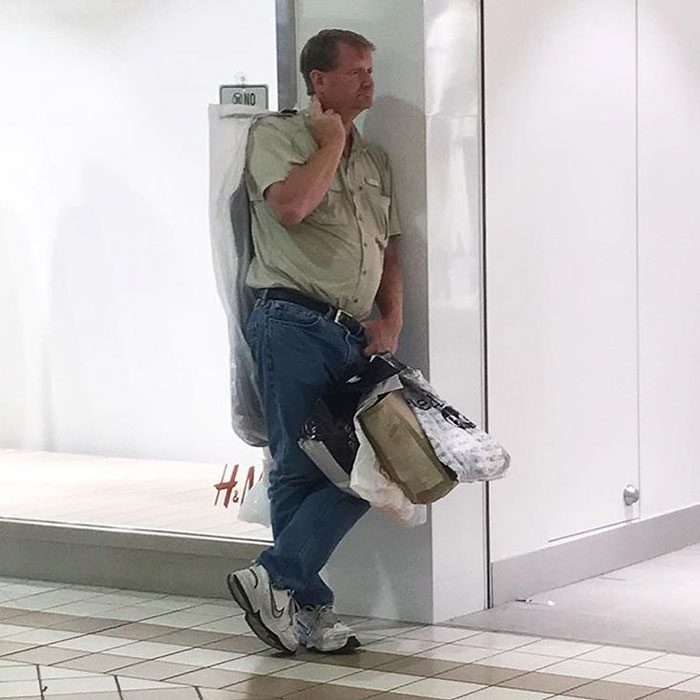 Hombres esperando a mujeres de compras