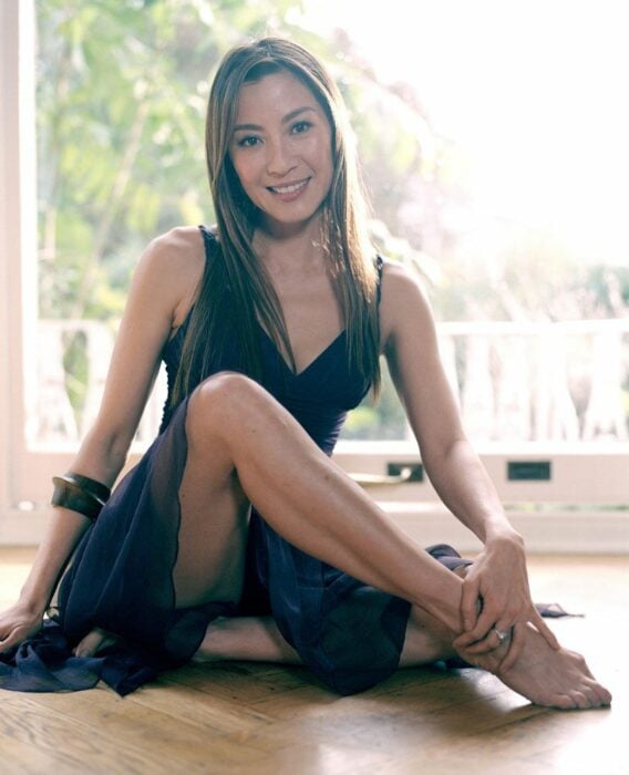 Michelle Yeoh sentada con vestido negro