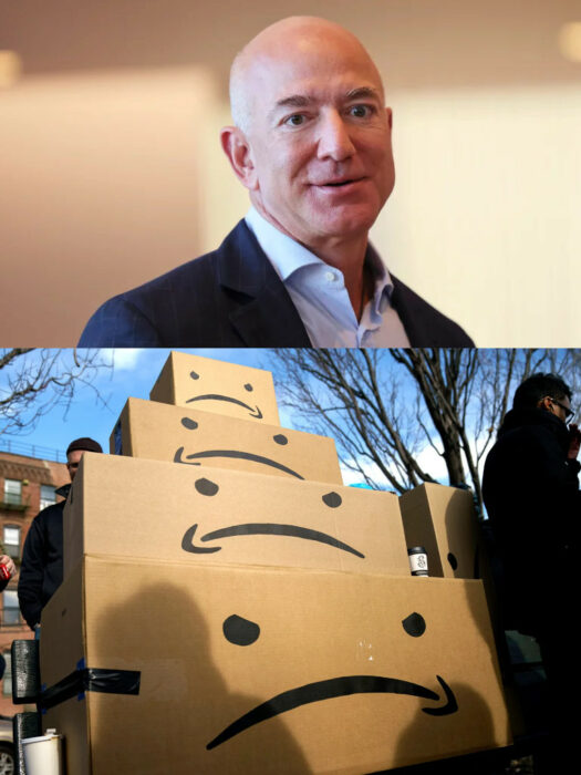 Jeff Bezos de traje haciendo una mueca y cajas artísticas de amazon con caritas tristes en el logo las cuales fueron puestas en una plaza al aire libre