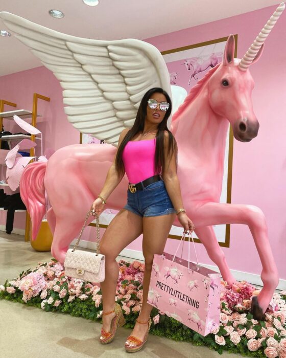 Mandy Rose pantaloncillo corto top rosa lentes de sol con bolsa de compra pretty little things con un unicornio pegaso rosa